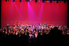Members of the African American Arts Institute perform on stage.
